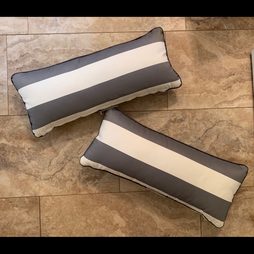 Two gray and white striped long pillows